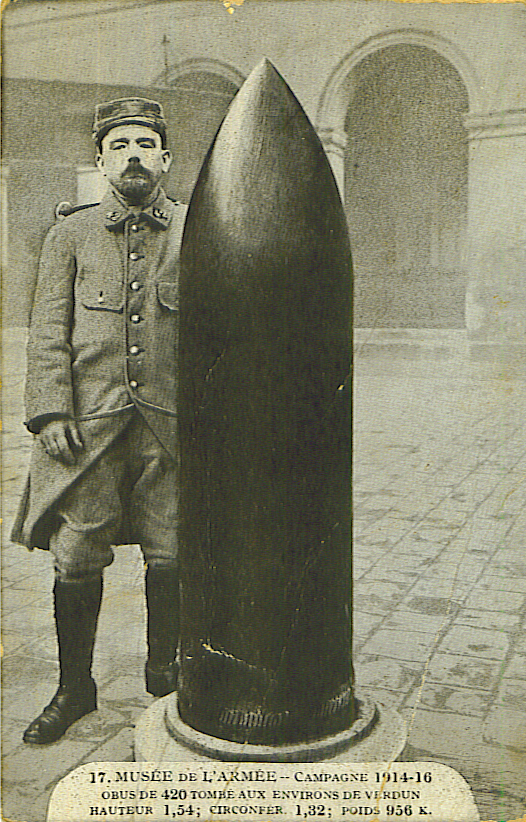 French soldiers stands next to a 420mm shell